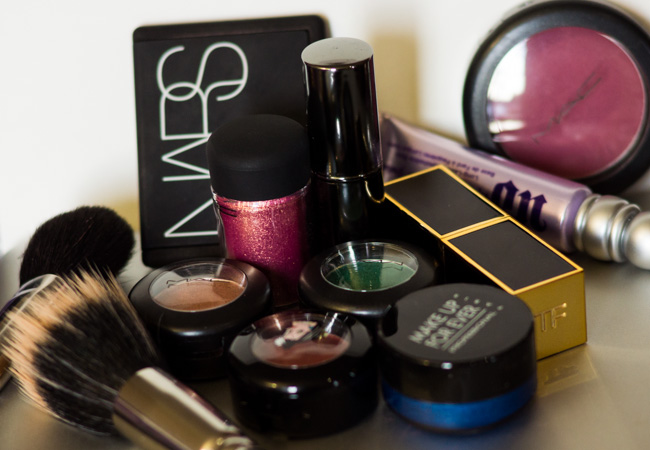 A cluster of colorful cosmetics, includes MAC, NARS, Tom Ford, Make Up For Ever, Urban Decay and Smashbox.